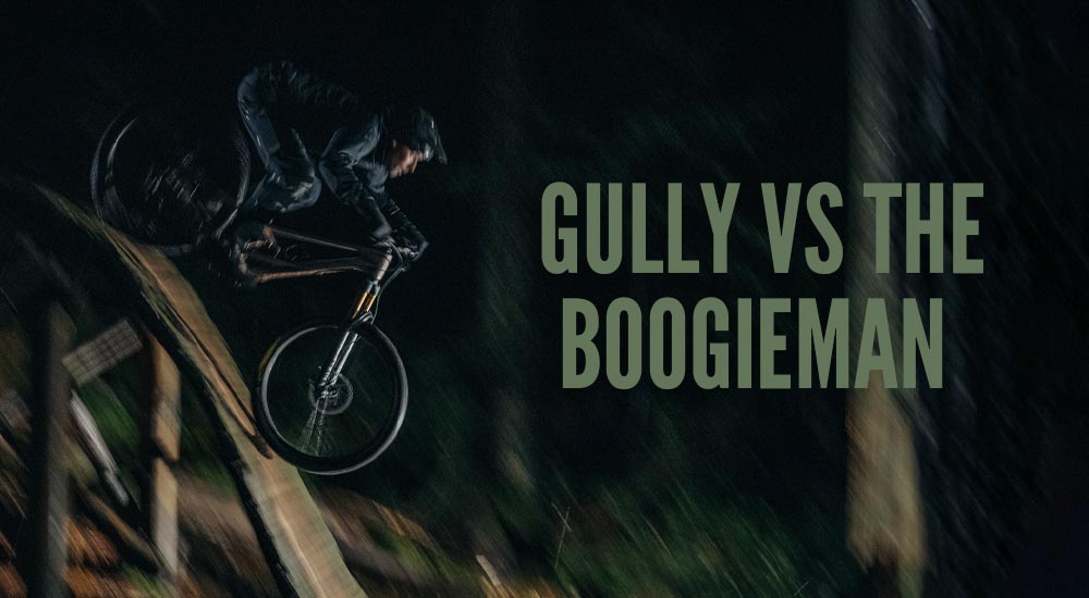 Geoff Gulevich riding the Boogieman trail at night, illuminated by strategically placed Lezyne bike lights on a double black diamond feature.