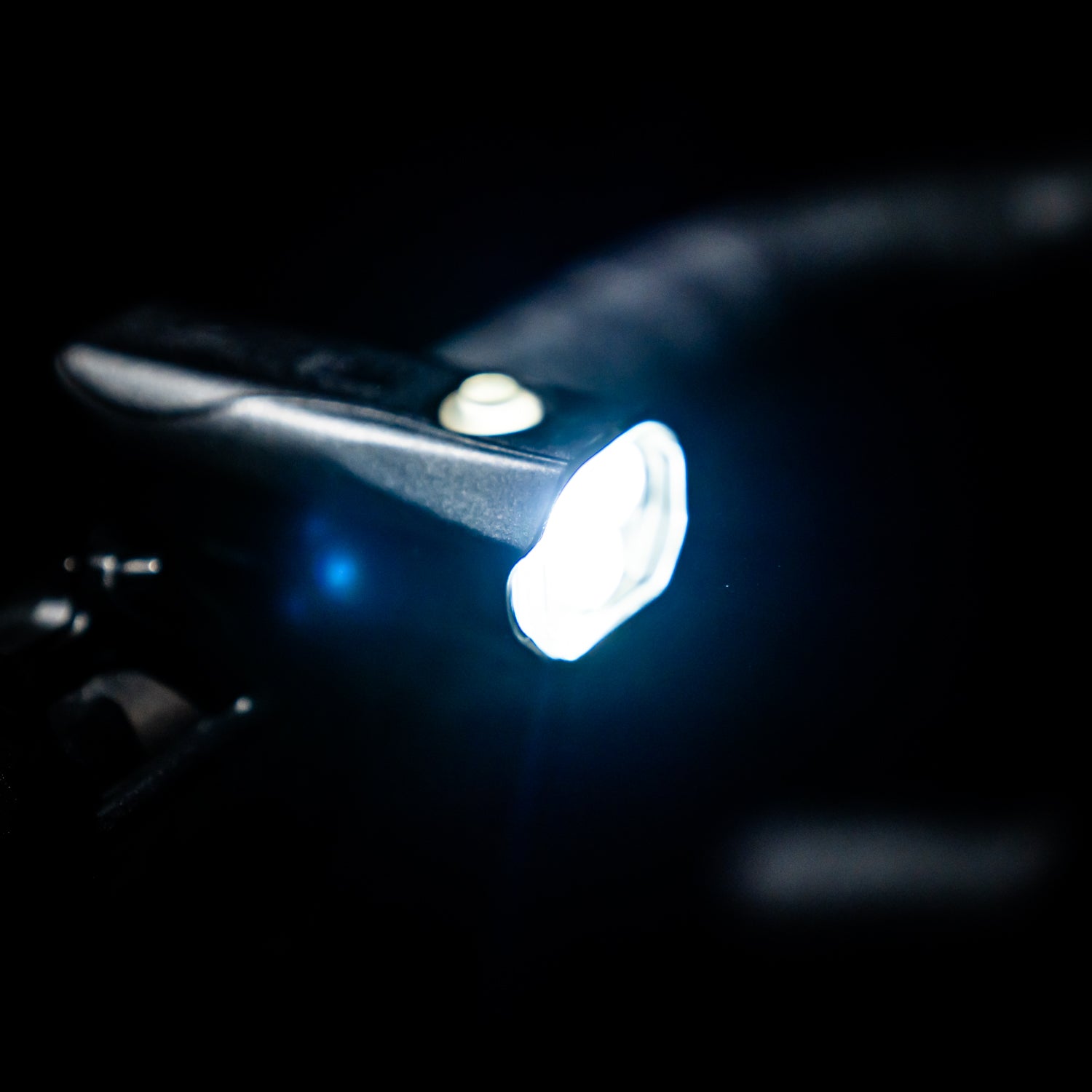 Close side view of Lezyne KTV Drive Pro 300+ LED front bike light mounted on gravel bike, emitting a super bright white light beam for traffic safety.