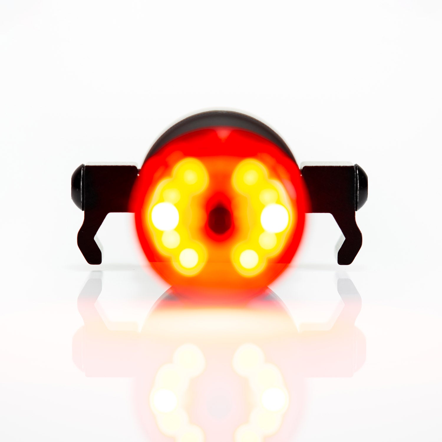 Front view of SADDLE Ai ALERT 250 REAR round-shaped LED rear bicycle light, a premium safety option for night rides!