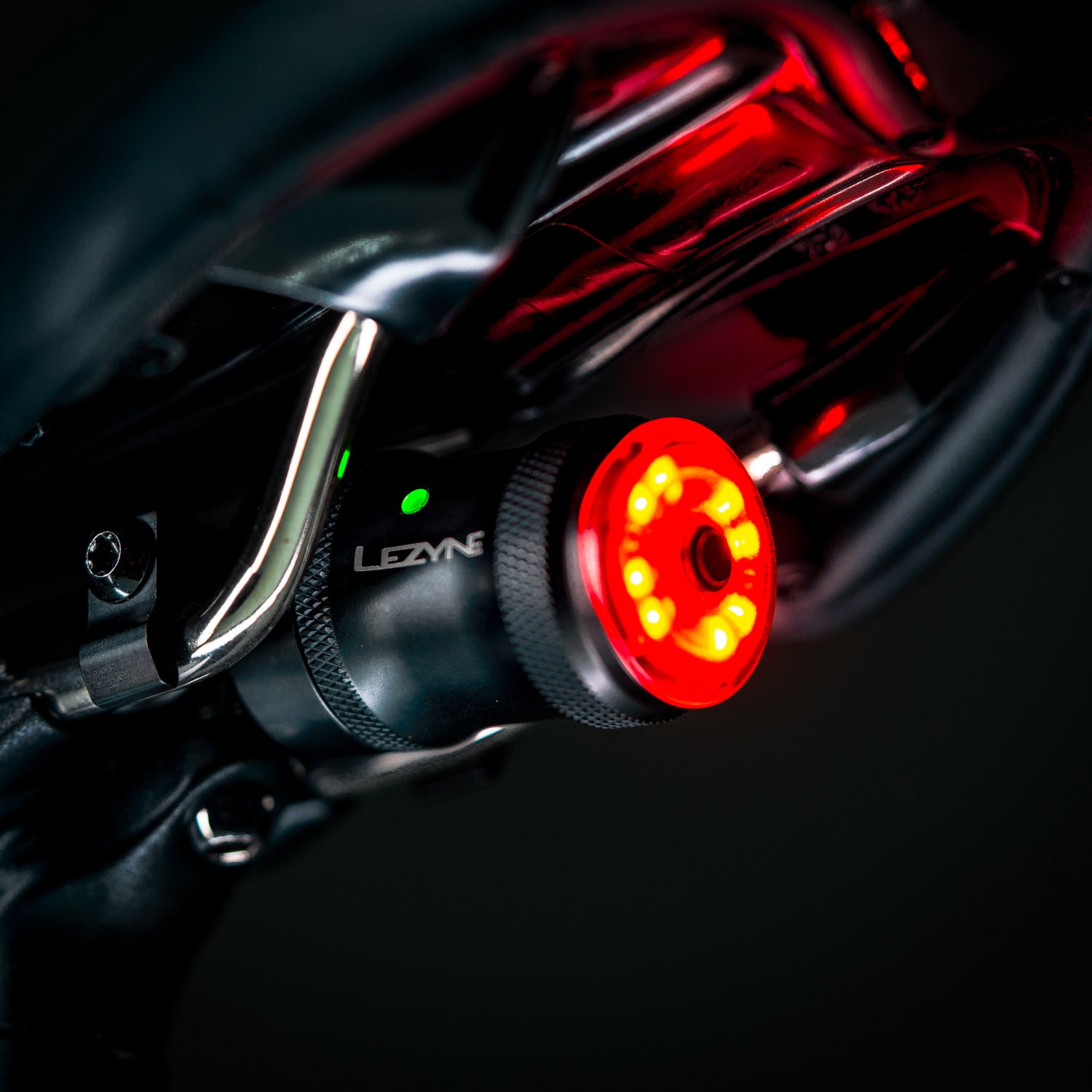 Side view close-up of SADDLE Ai ALERT 250 REAR LED bike light mounted on road bike, featuring 10 super-bright LEDs and 60-hour runtime in Femto mode.