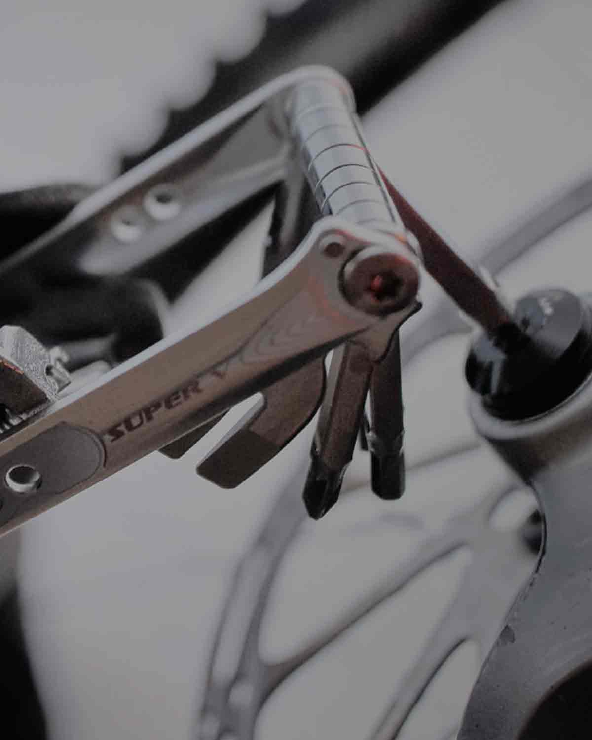 A multi tool tightening a screw.