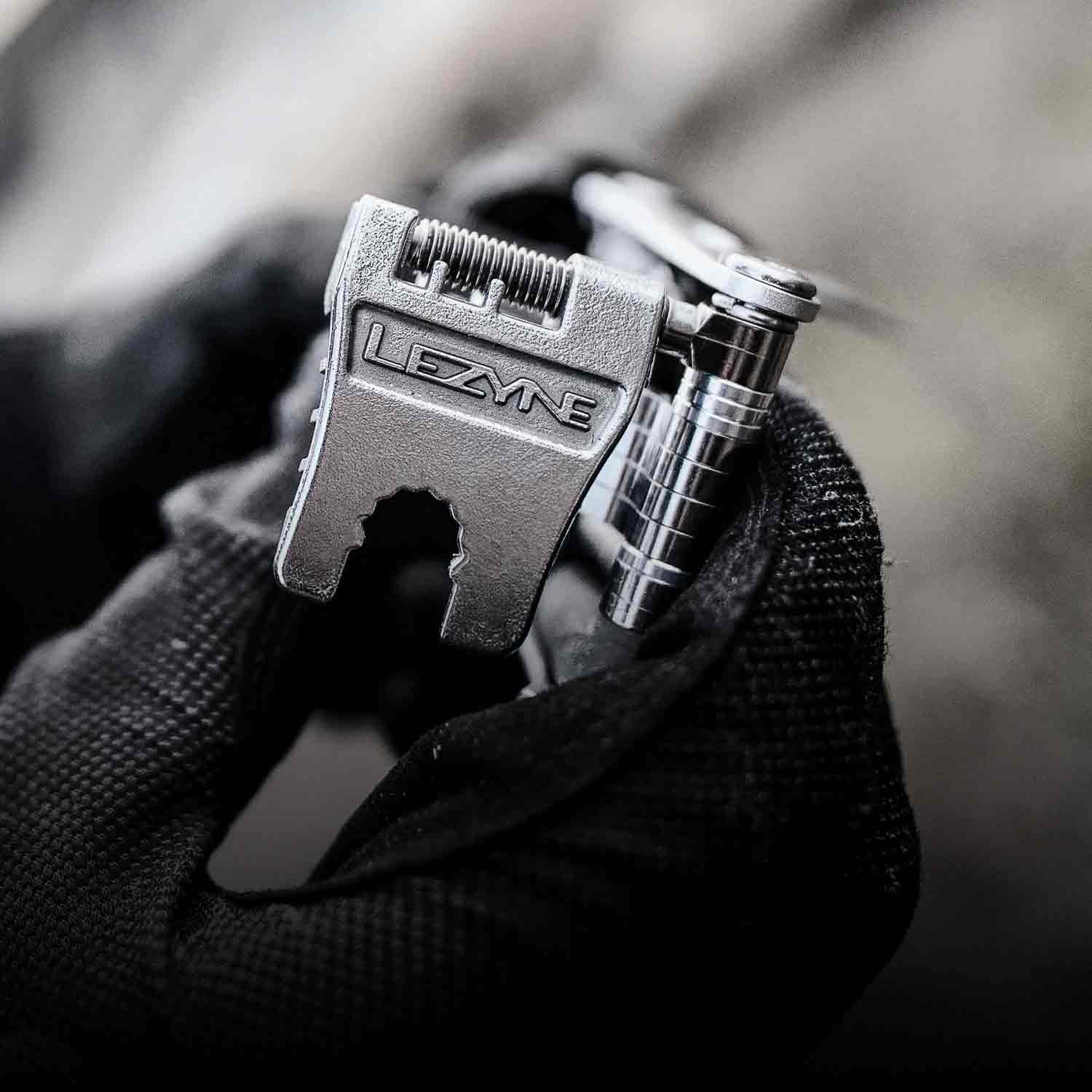 A fold out tool with the word Lezyne printed on it.