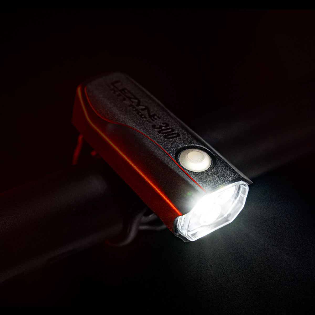 Lezyne KTV Drive Pro 300+ LED front bike light, mounted on commuter bike handlebar, emitting a super bright light beam.