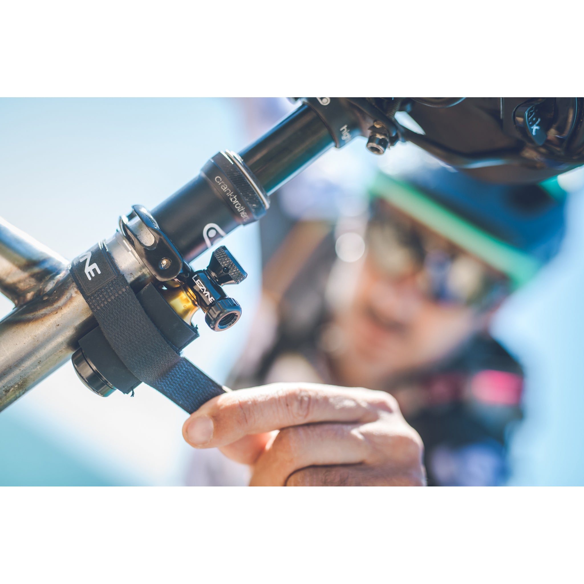 Lezyne Tubeless CO2 Blaster securely strapped to bike seat post using included Velcro strap for easy portability.