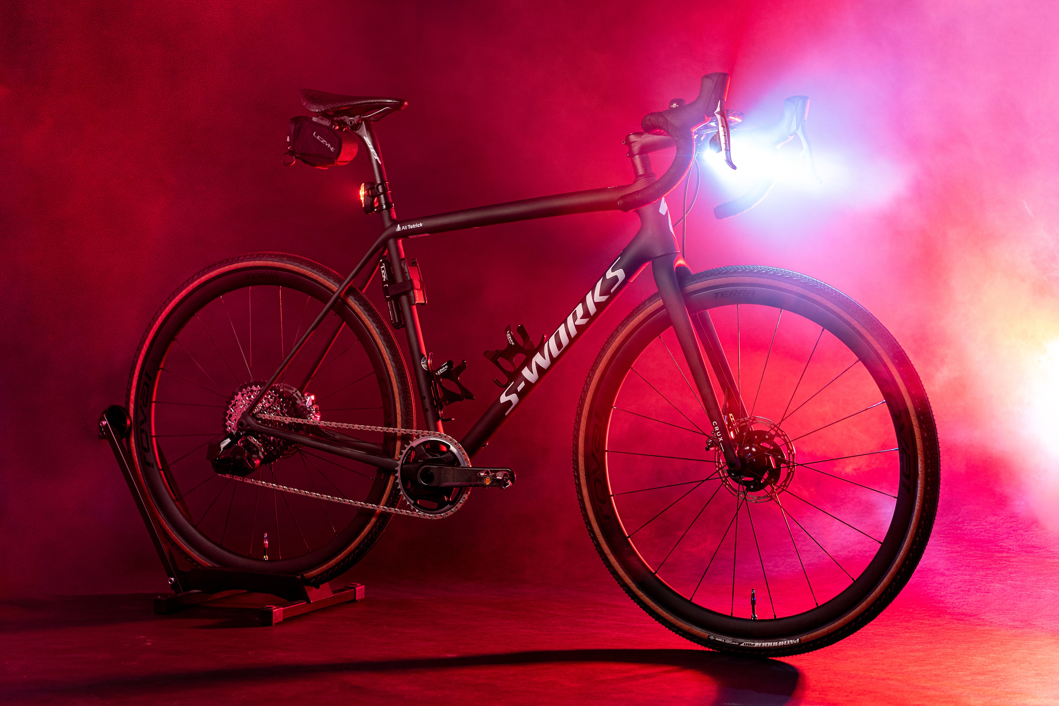 A bicycle in a red foggy environment with the word S-Works printed on it.