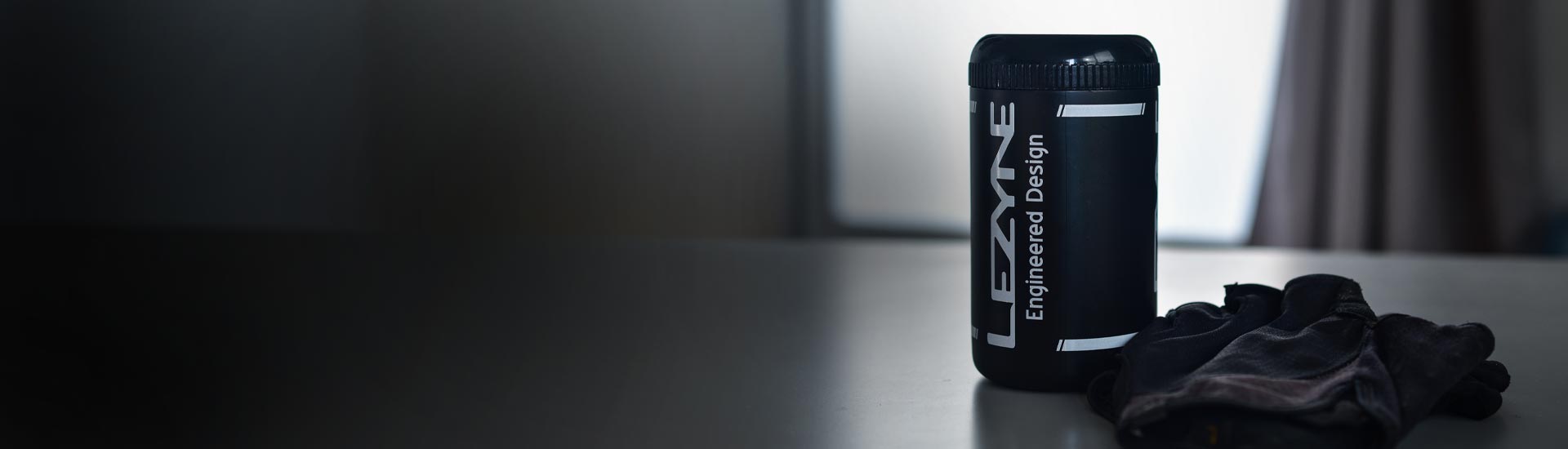A phone and a light mounted to bicycle handlebars.