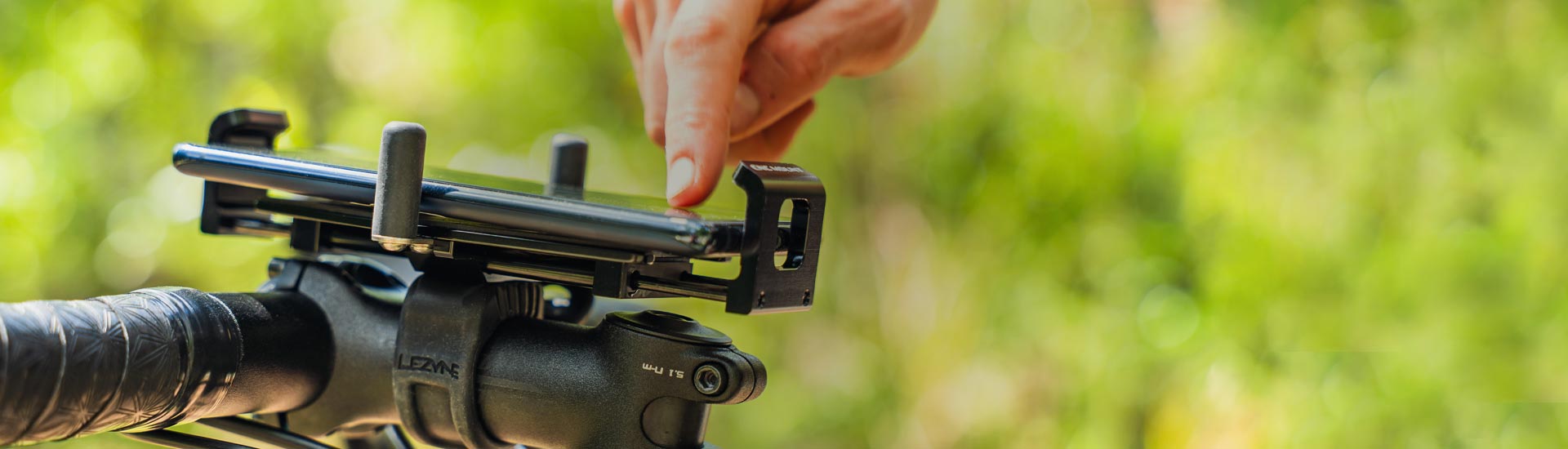 A phone mounted to bicycle handlebars.