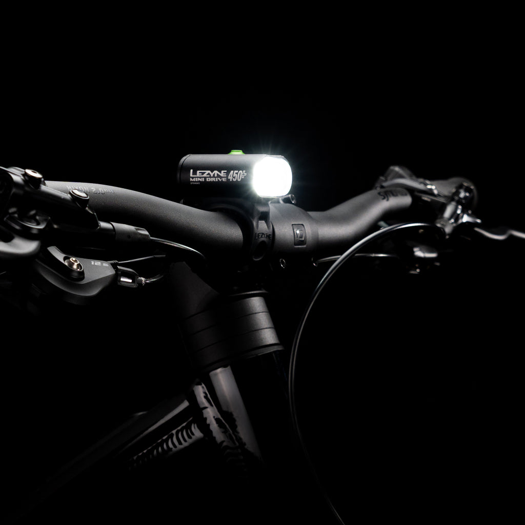 Studio shot of the Lezyne Mini Drive 450+ Front mounted on a bike handlebar