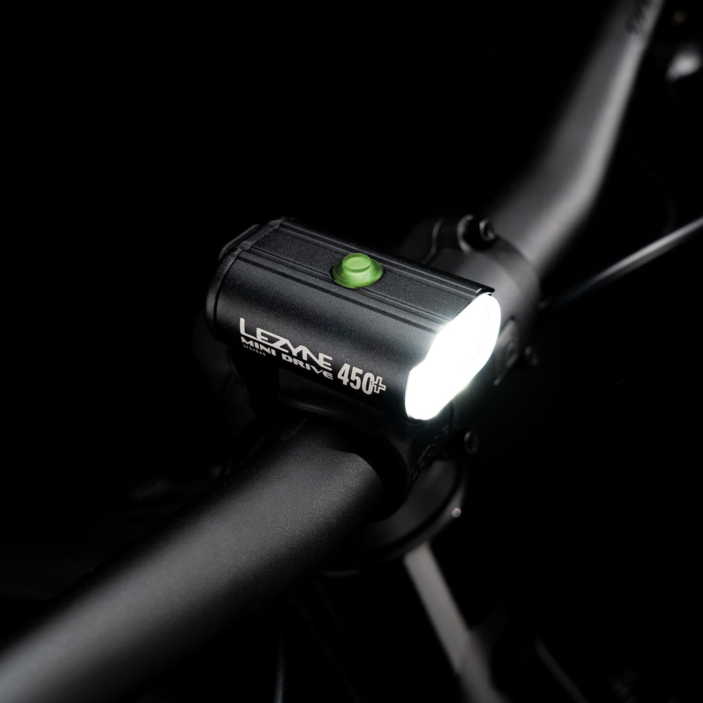 Top-view studio shot of the Lezyne Mini Drive 450+ Front with illuminated multifunction button
