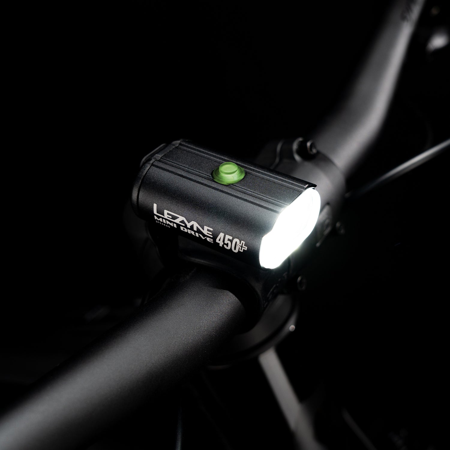 Top-view studio shot of the Lezyne Mini Drive 450+ Front with illuminated multifunction button