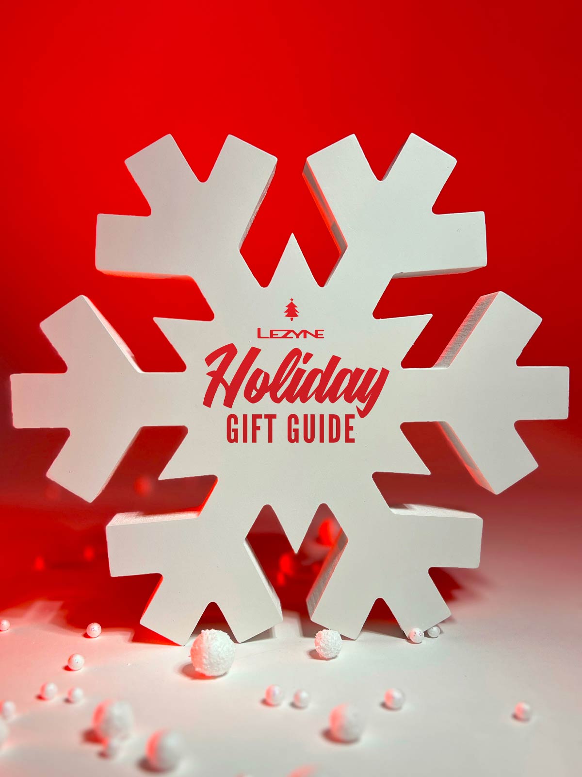 Holiday Shopping Guide logo on a white oversized snowflake, with tiny snowballs scattered about.