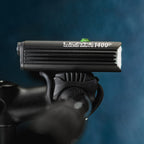Side view of the MACRO DRIVE 1400+ front LED bike light mounted on road bike handlebar, ideal for cycling after sunset.