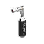 Silver Lezyne Trigger Drive CO2 inflator with CO2 cartridge, featuring lightweight aluminum design and trigger valve operation.
