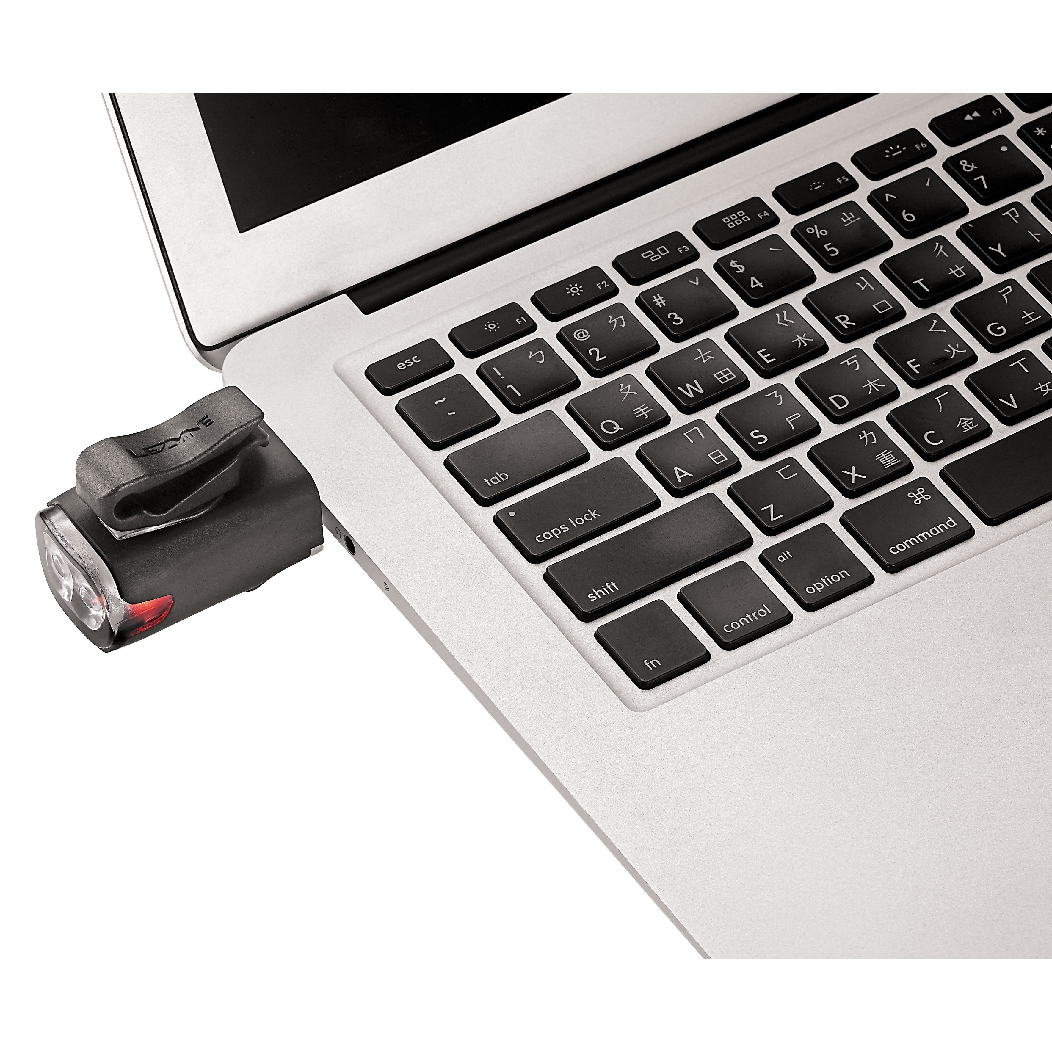Black  KTV Drive front bike light charging using a laptop