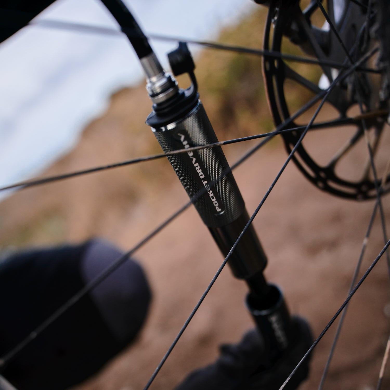 Lezyne Pocket Drive HV. Compact high volume hand pump in use on high volume tire.