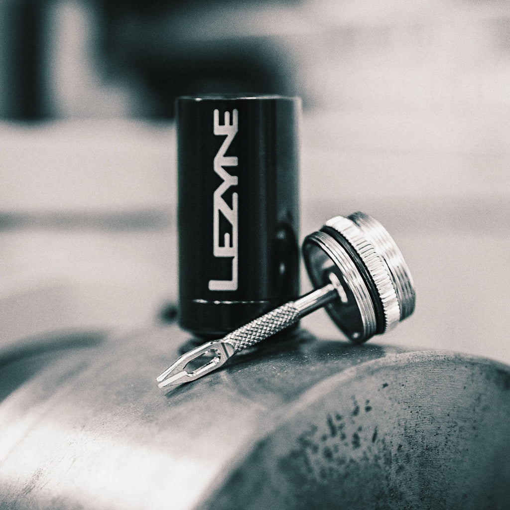 Lezyne Tubeless Kit with sticky tire plugs and durable stainless steel tool, stored in a lightweight aluminum container.